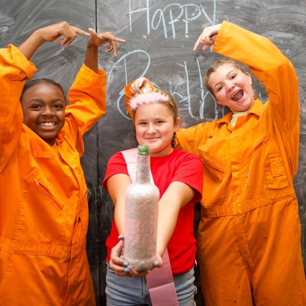 a couple of young men standing next to a child